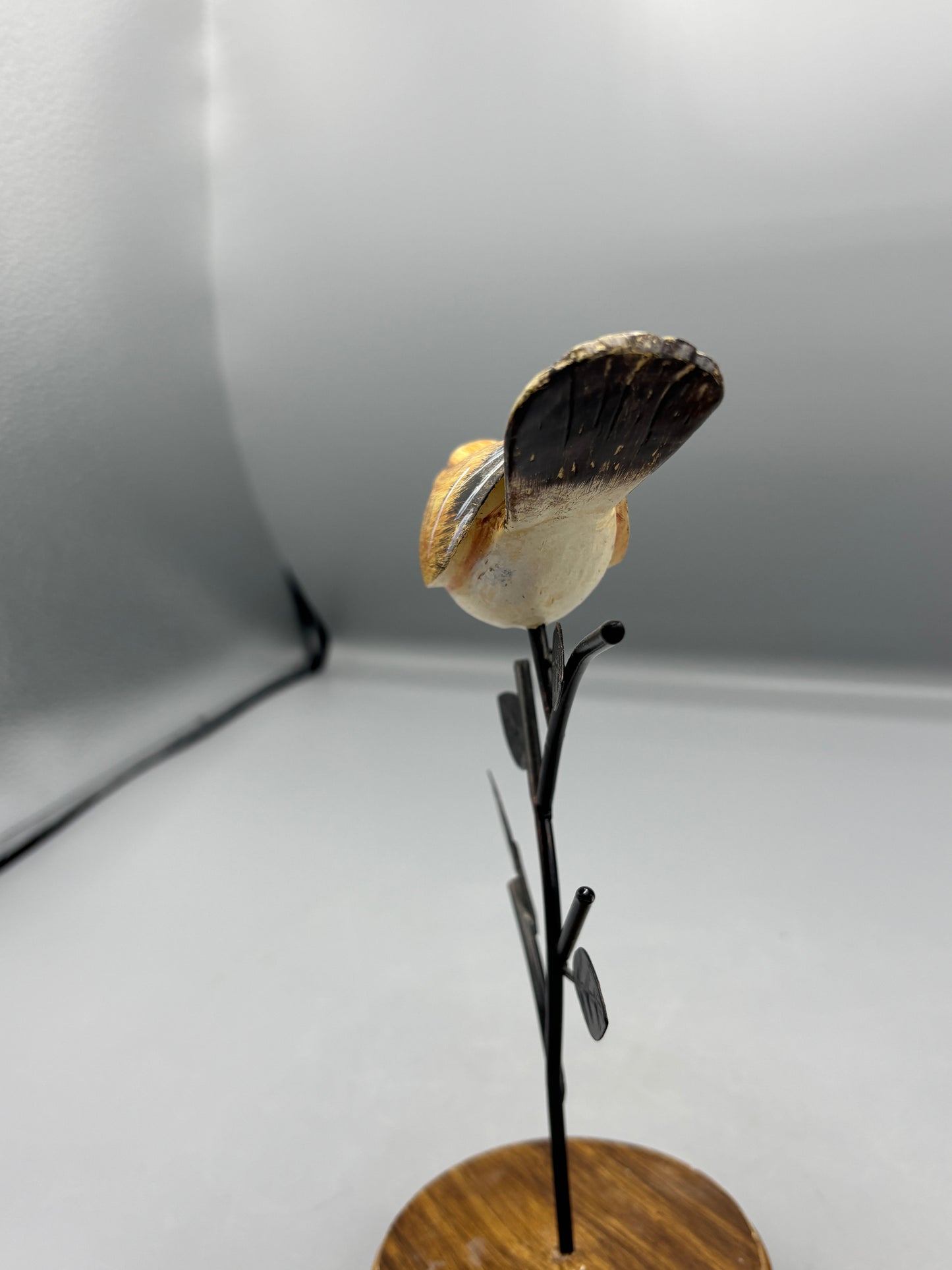 Carved Wren bird on metal branch