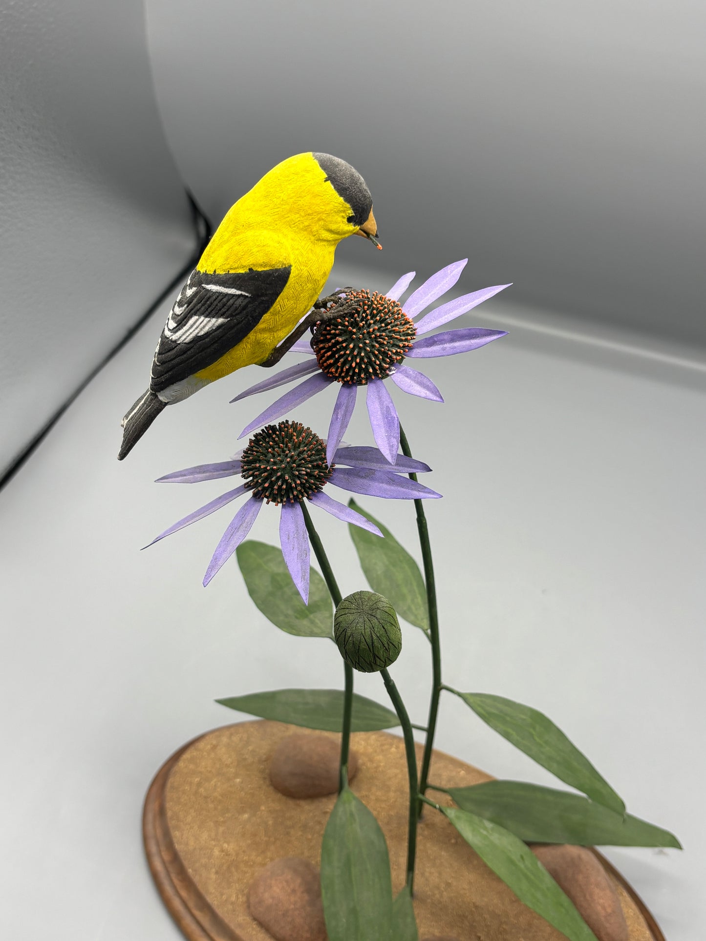 American gold Finch thistle sculpture on metal flowers