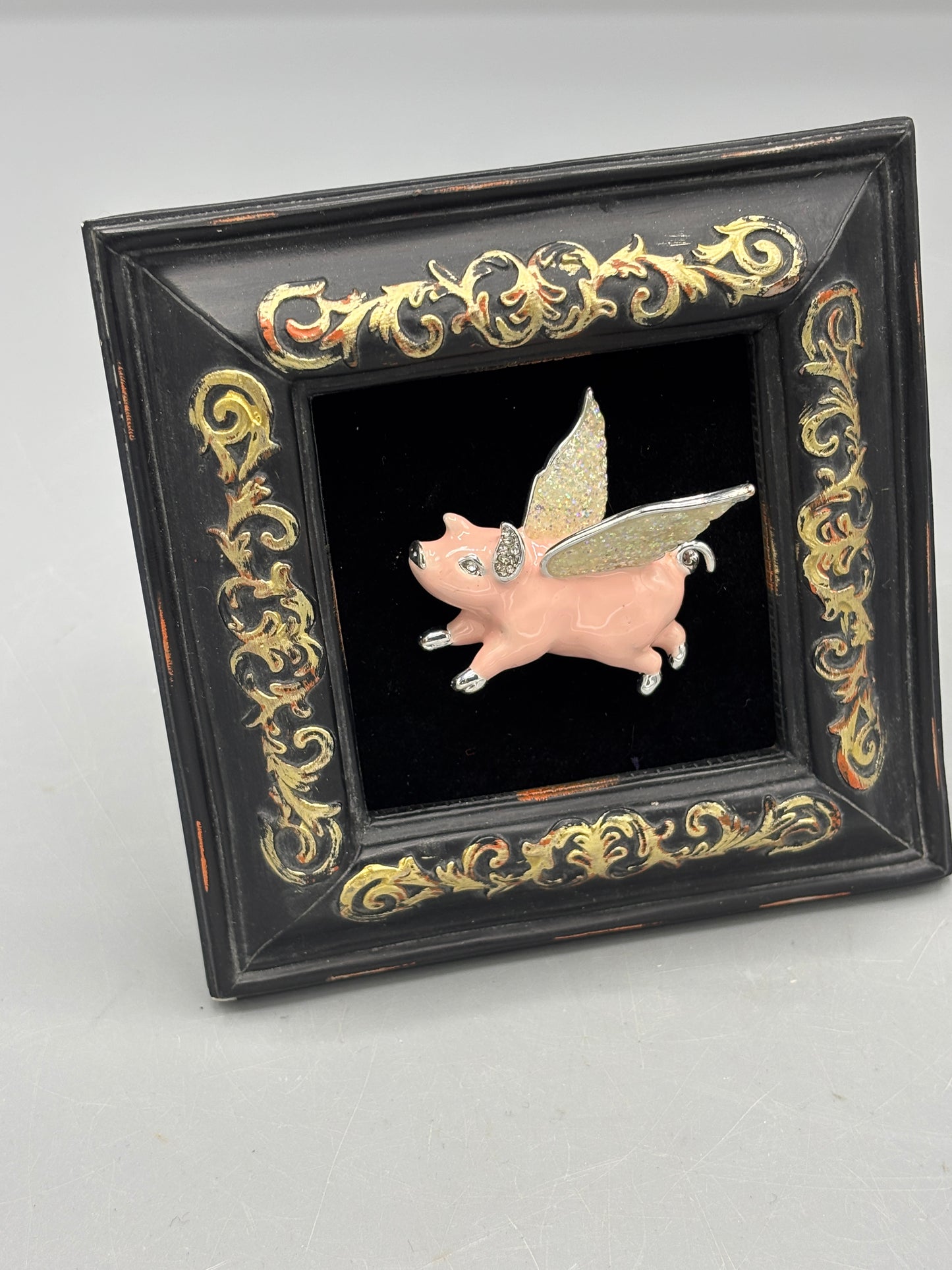 Black frame with pink flying pig