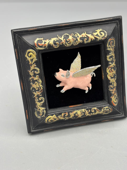 Black frame with pink flying pig