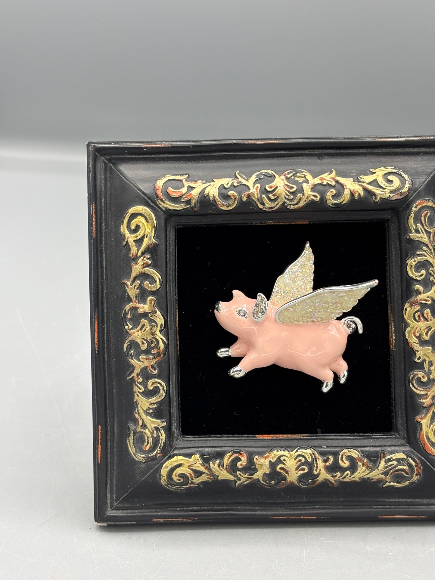 Black frame with pink flying pig