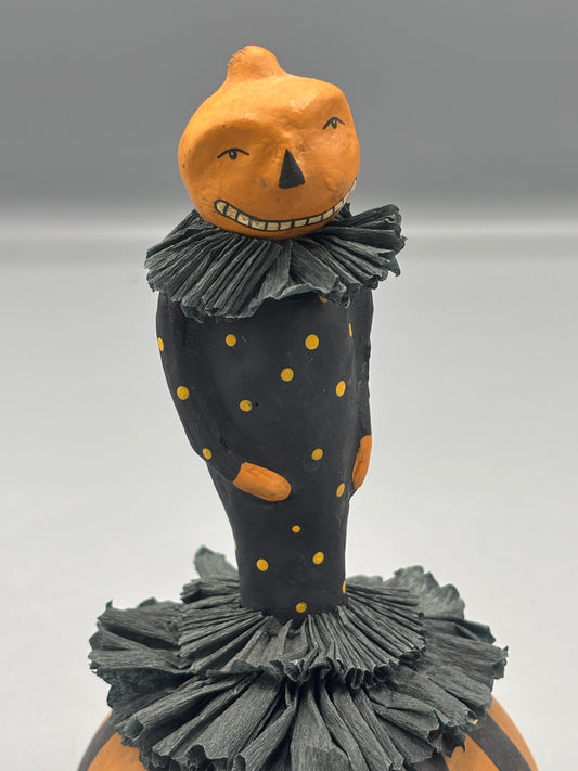 Standing Pumpkin head girl figure on striped base