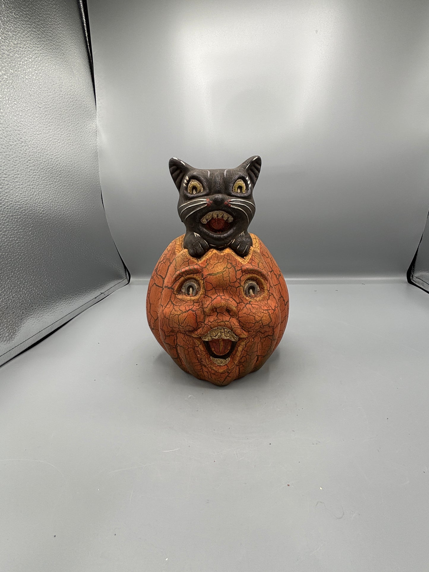 Vintage Halloween cat on pumpkin