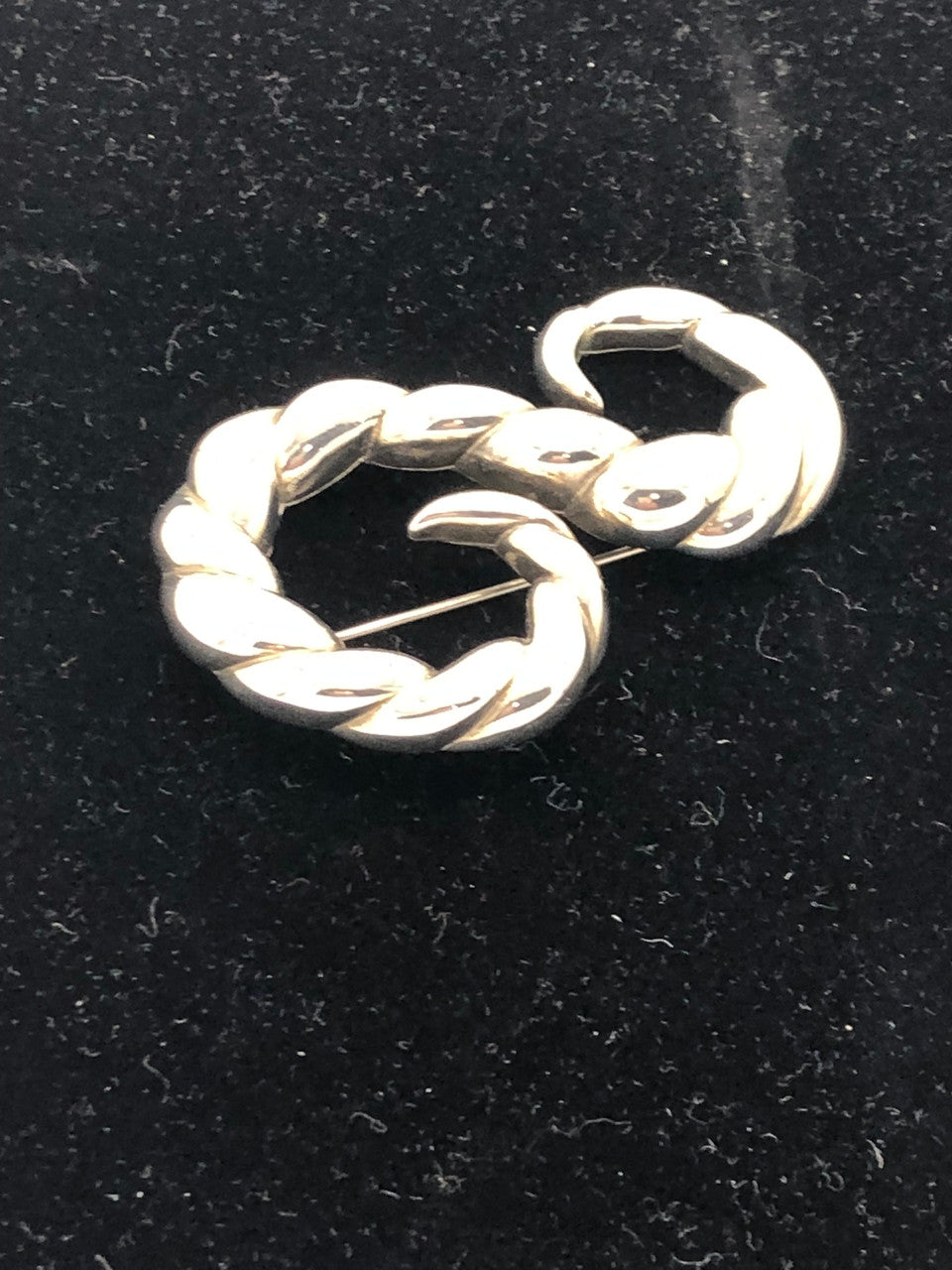 Silver tone swirl brooch