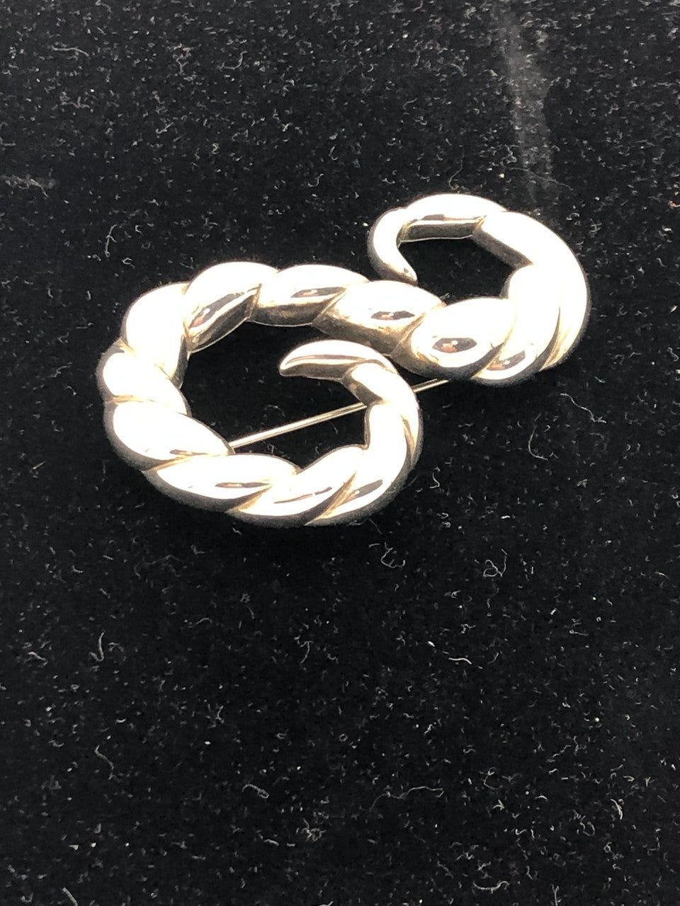 Silver tone swirl brooch