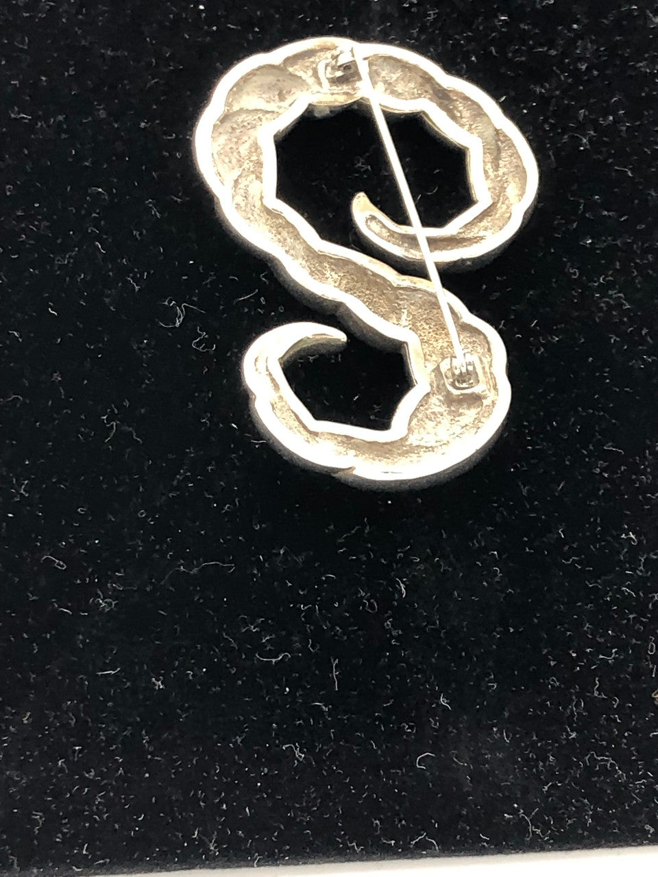 Silver tone swirl brooch