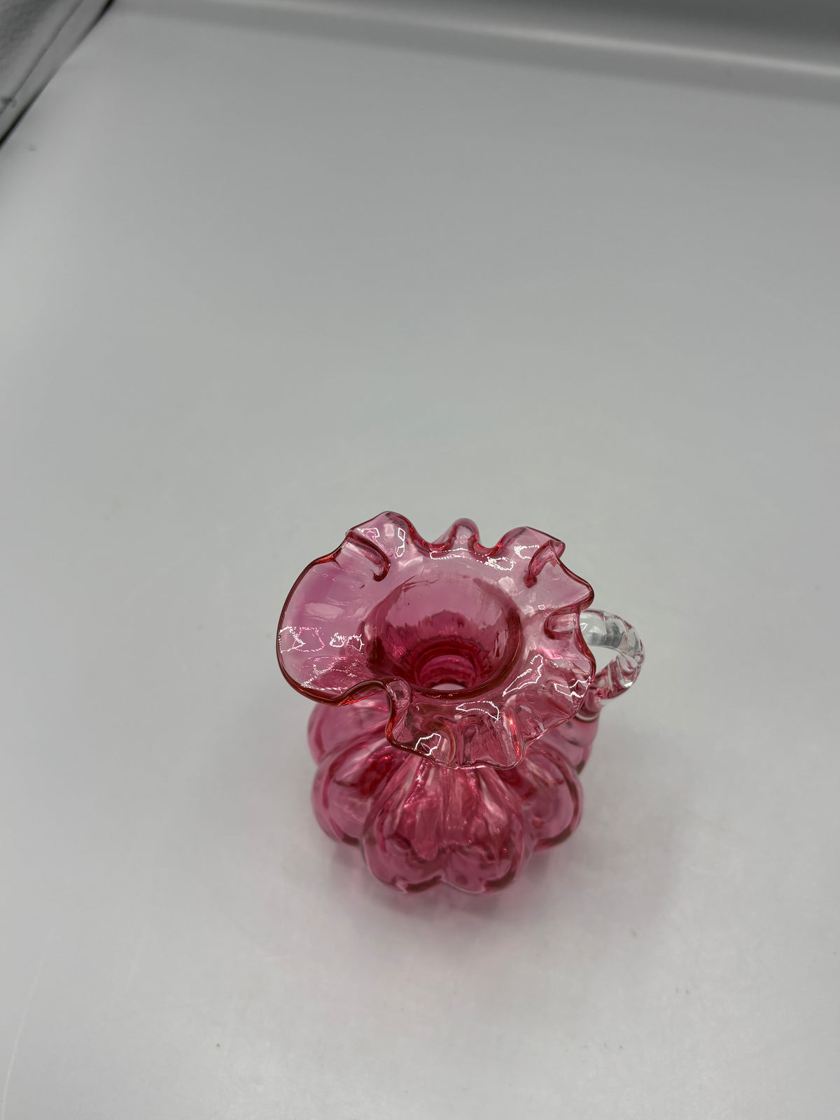 Vintage Fenton cranberry pitcher with clear handle