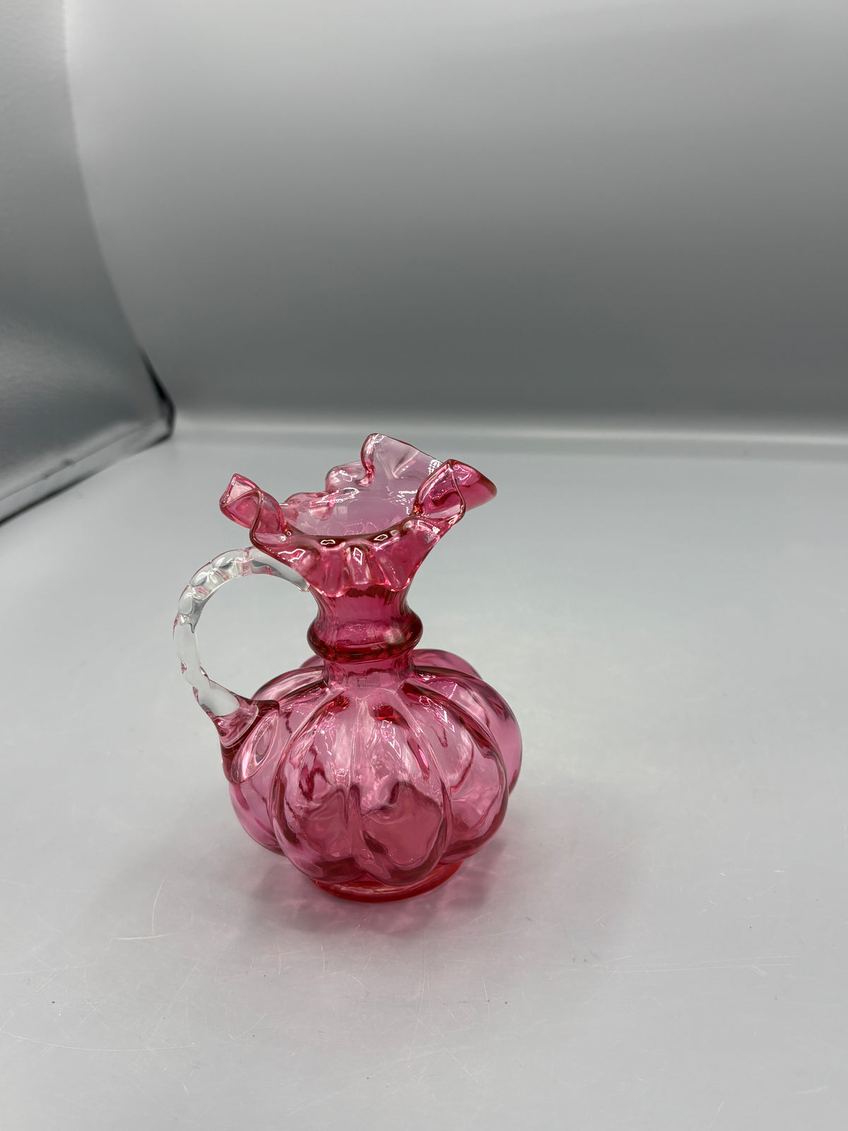 Vintage Fenton cranberry pitcher with clear handle