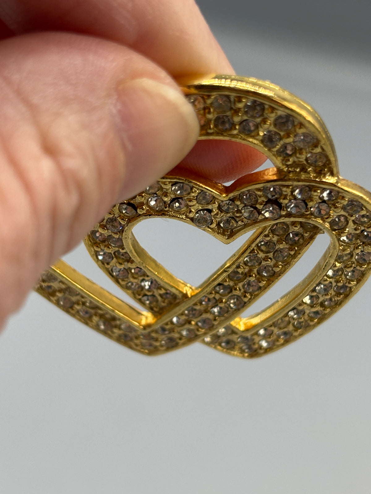 Gold tone double heart & crystal brooch