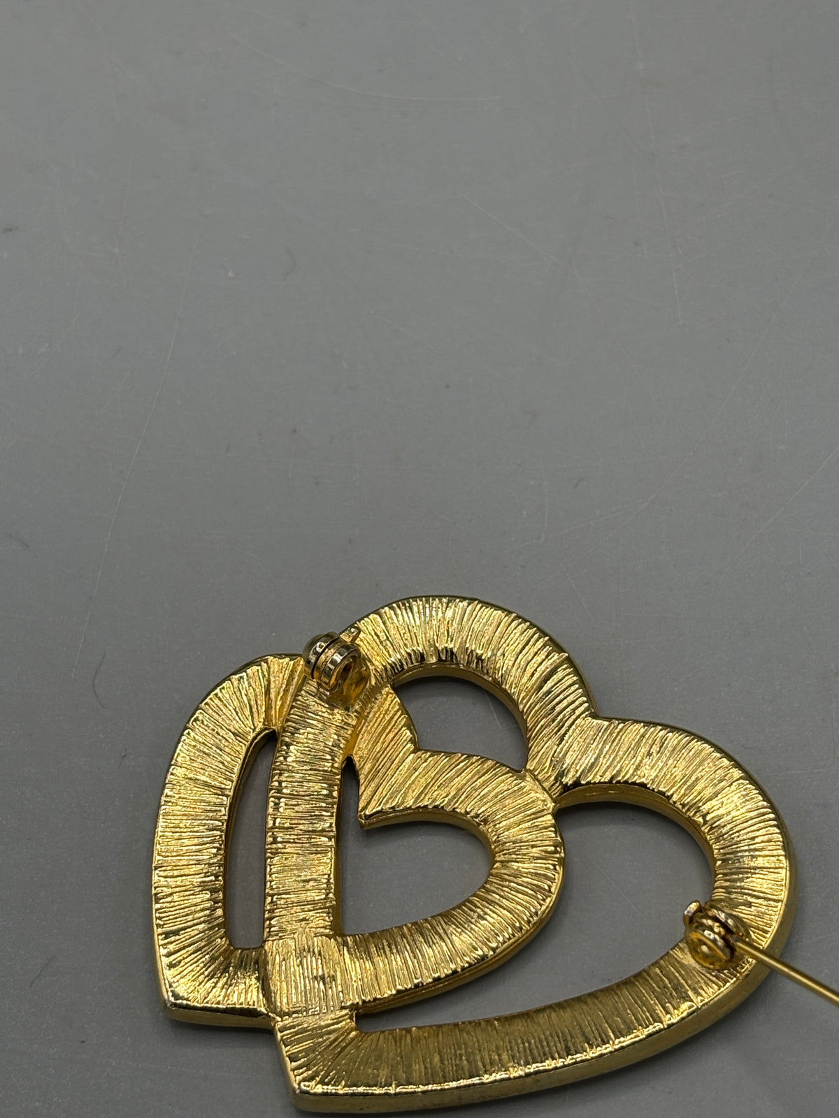 Gold tone double heart & crystal brooch