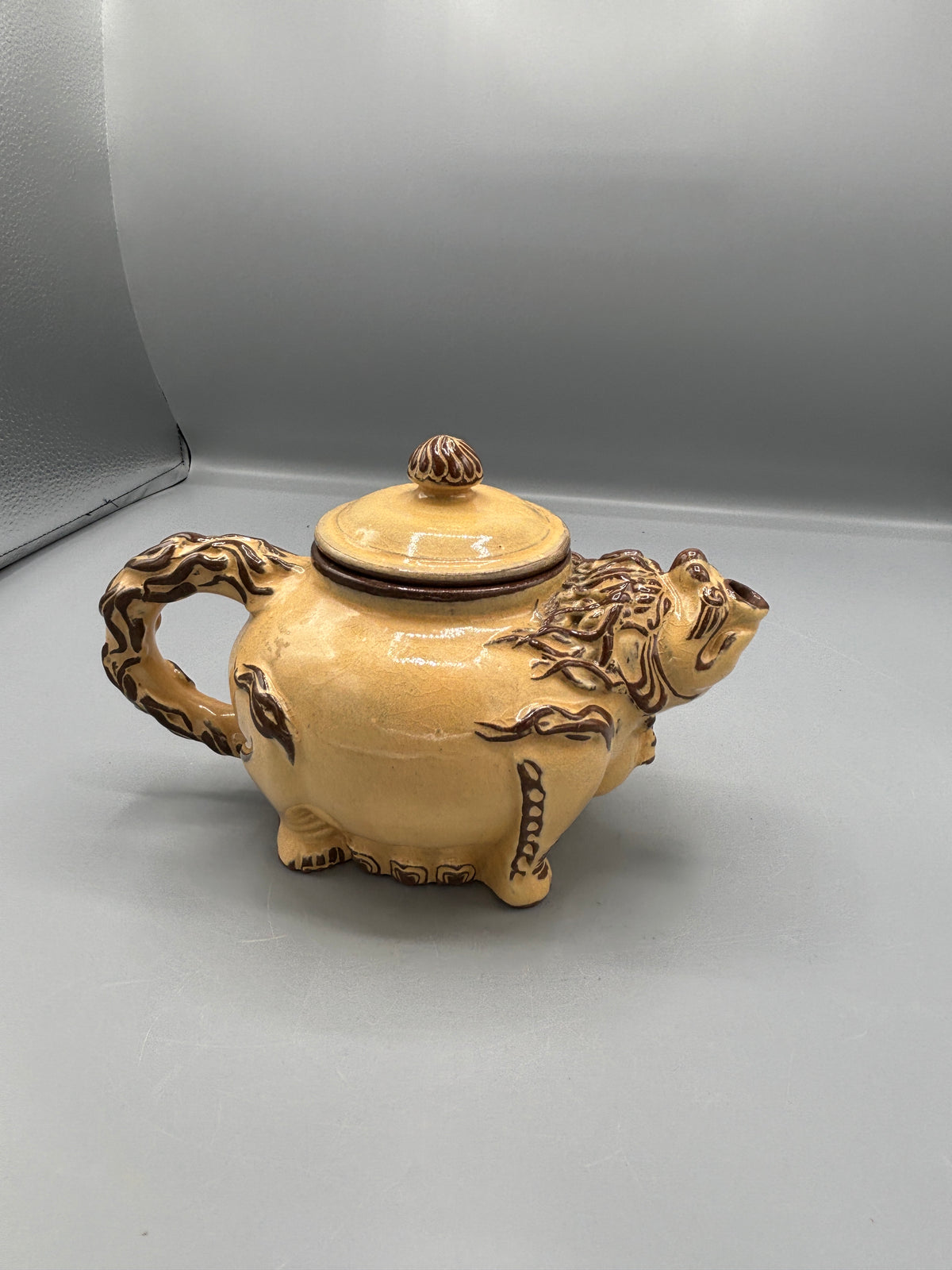 Light Tan ceramic teapot with animal design