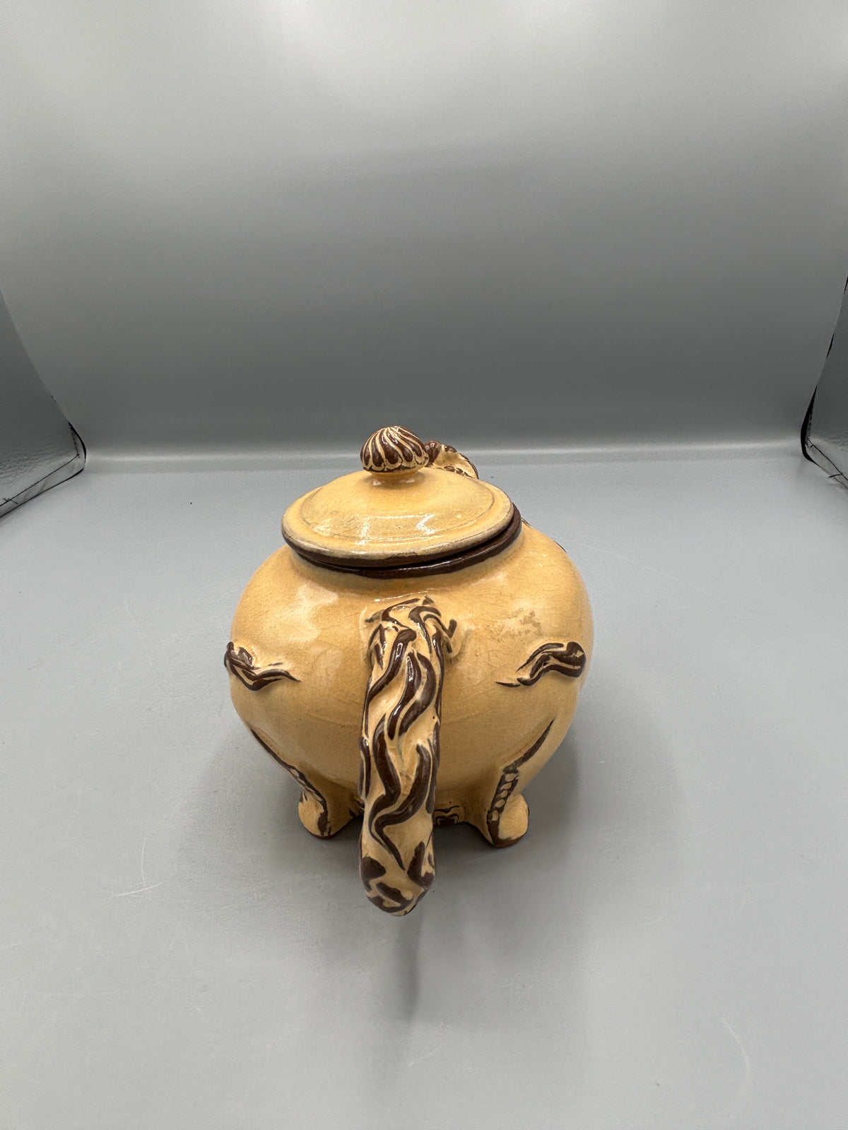 Light Tan ceramic teapot with animal design