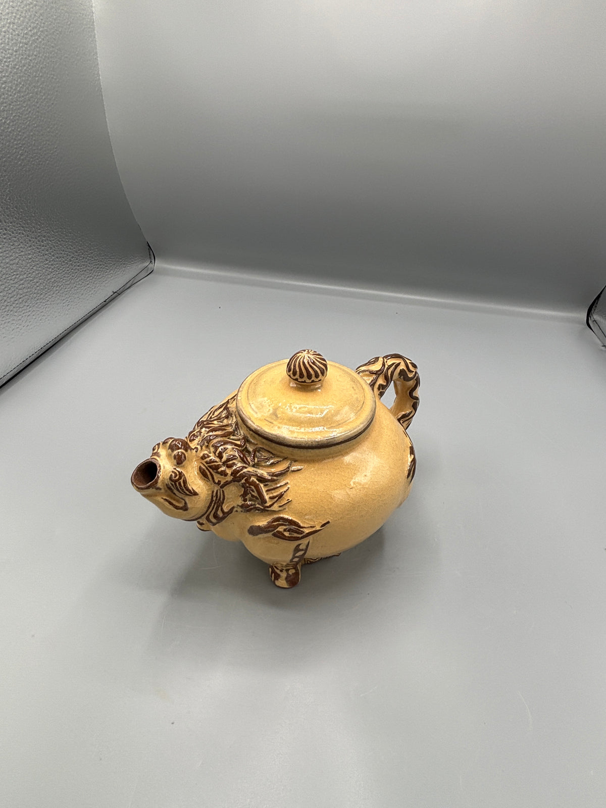 Light Tan ceramic teapot with animal design