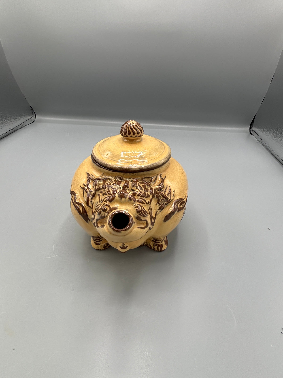 Light Tan ceramic teapot with animal design