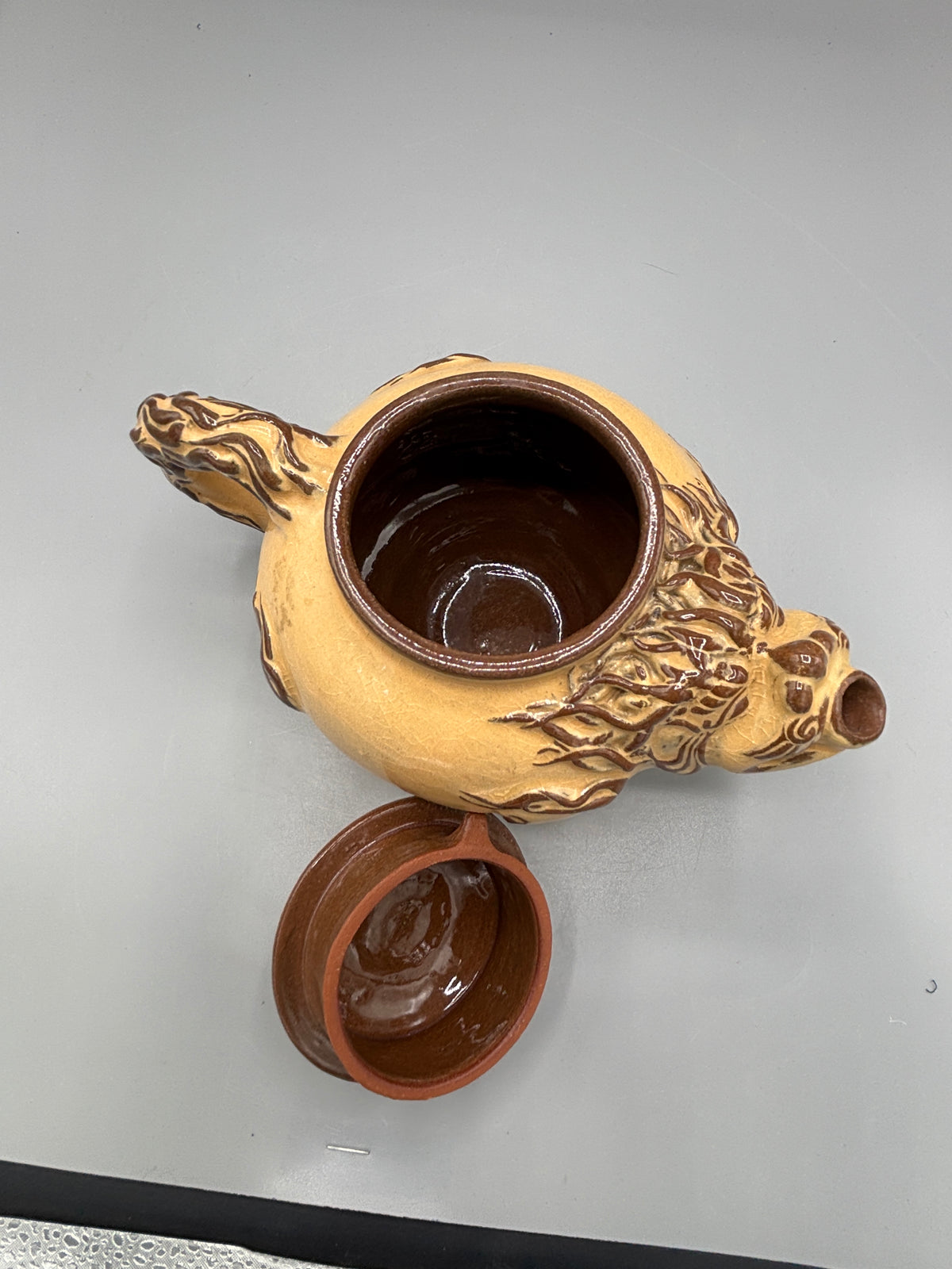 Light Tan ceramic teapot with animal design